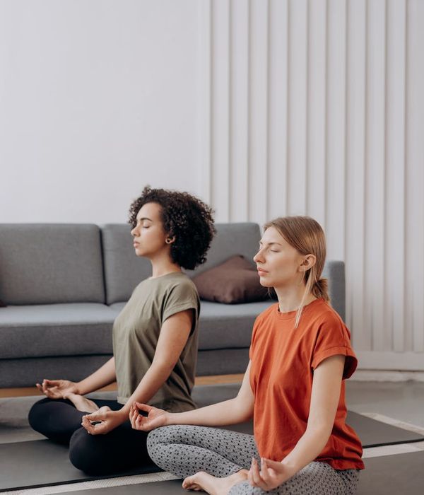 Person practicing a calm yoga pose in a minimalist room.